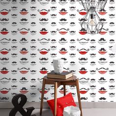 the wallpaper in this room is designed to look like mustaches and red pillows