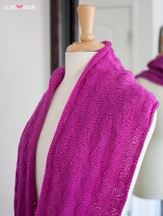 a purple knitted shawl on a mannequin