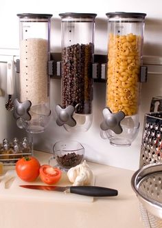 the food dispenser is hanging on the wall above the kitchen counter top