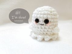 a small white crocheted object with black eyes