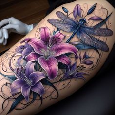 a tattoo with purple flowers and dragonflies on it