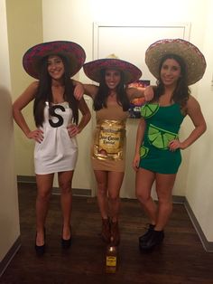 three women dressed in costumes posing for the camera