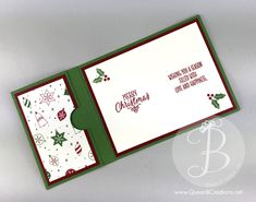 an open christmas card with holly and snowflakes