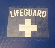 a lifeguard sticker on the side of a car with white cross in it