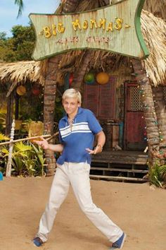 an older man swinging a baseball bat in front of a sign that says bob thomas