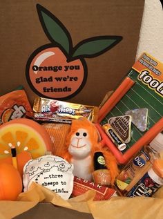 an orange box filled with snacks and candy