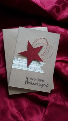 a card with a red star on it and music notes in the bottom right corner