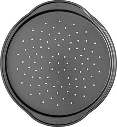 a black round pan with white dots on it