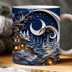 a coffee mug with a house and trees on it in front of a night sky