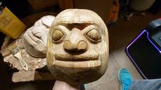 a carved wooden mask sitting on top of a table