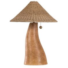 a lamp that is made out of wood and has a brown shade on the top