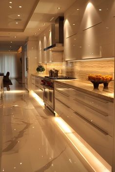 a modern kitchen with white cabinets and marble flooring