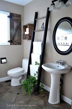 a bathroom with a ladder leaning against the wall next to a white toilet and sink