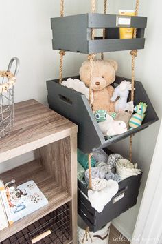 a teddy bear sitting on a swing in the corner of a room with other items