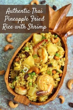 authentic thai pineapple fried rice with shrimp and cashews in a wooden spoon