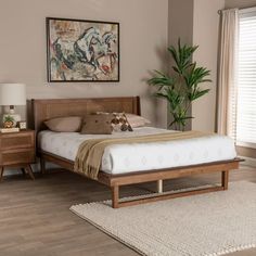 a bed sitting on top of a wooden floor next to a dresser and window in a bedroom