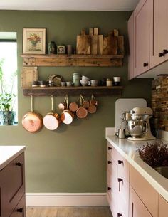 a kitchen with pots and pans hanging on the wall