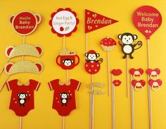 a bunch of cupcake toppers and cake picks on a yellow background with monkeys