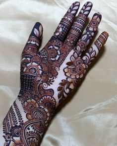 the hand is decorated with henna designs on it