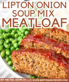 two slices of meatloaf on a plate with peas