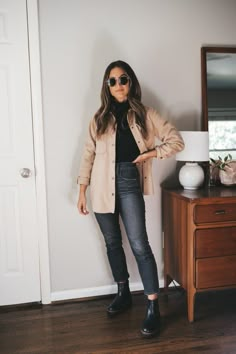 ashley wearing a black turtleneck, tan shacket, washed black jeans, black Chelsea boots, and round gold frame sunglasses Neutral Shacket, Style A Shacket, Black Chelsea Boots Outfit, Chelsea Boot Outfits Women, Black Jeans Outfit Fall, Shacket Outfit Women, Washed Black Jeans, Shacket Outfit, Chelsea Boots Outfit