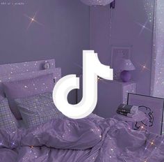 there is a bed with purple comforter and pillows in the room that has stars all over it