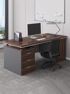 an office desk with a monitor and keyboard on it