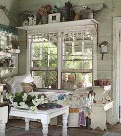 a living room filled with furniture and lots of windows