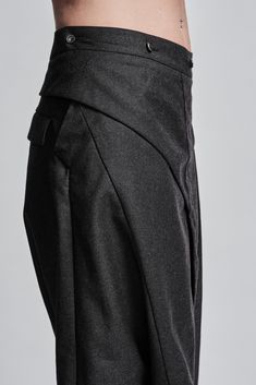 "Drop Crotch Trouser with Asymmetrical Front Closure__ // EXPRESS DELIVERY ONLY __Elastic Backside Waistband with Belt __2 Front Pockets __2 Rear Pockets __Asymmetrical Hidden Front Closure __Lightweight Wool Fabric model__ bust 92 (36\"), waist 72 (28\"), hips 102 (40\"), biceps 28 (11''), height 177 (5'8\"), kg 65 (143 lbs) model wears size M | color: dark grey fabric__ 100 wool care__ dry clean sizing__ size XS (US 4, EU 34, IT 40, UK 8) bust: 79-84 cm / 31\"-33\" waist: 60-65 cm / 23.5\"-25. Asymmetrical Skirt With Belt Loops For Work, Workwear Bottoms With Belt Loops And Asymmetrical Hem, Asymmetrical Hem Bottoms With Belt Loops For Work, Avant-garde Fitted Asymmetrical Skirt, Fitted Asymmetrical Avant-garde Bottoms, Avant-garde Fitted Asymmetrical Bottoms, Avant-garde Asymmetrical Fitted Bottoms, Elegant Asymmetrical Bottoms With Pockets, Avant-garde Fitted Trousers