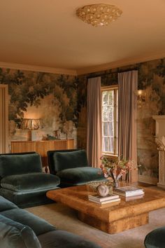 a living room filled with furniture and walls covered in floral wallpaper, along with a fire place