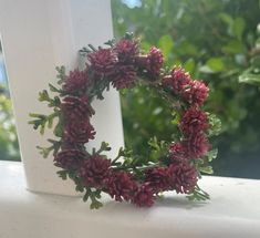 a close up of a wreath on a window sill