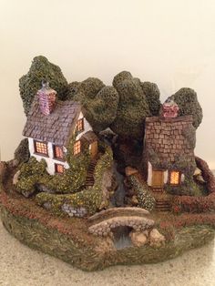 two small houses are sitting on top of a rock