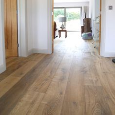 an empty room with hard wood floors and white walls