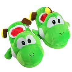 a pair of green slippers with googly eyes and ears on the feet,