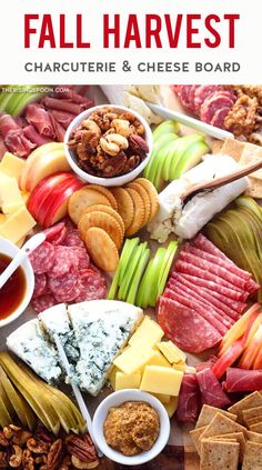 an assortment of cheeses, crackers, and meats on a platter