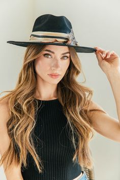 Our love of hats just got became a full-on obsession: meet the Navajo Feather Banded Hat in Black. The most chic, high-end hat we could've ever dreamed up. A hat this good needs to be worn as much as possible and with every single outfit! Hand made by artisans, incredible quality, pure suede, genuine leather trim around the crown, authentic feathers, chain, too many details to list! Will ship 8/28. The best part? It's super structured with an elastic band on the inside that will fit EVERYONE. Bt Black Brimmed Hat With Feather Trim, Black Bohemian Felt Hat For Kentucky Derby, Curved Brim Fedora With Feather Trim For Kentucky Derby, Black Brimmed Hat With Feathers, Wide Brim Fedora With Feathers For Rodeo, Black Western Hat With Feathers, Western Black Hat With Feathers, Wide Brim Hat With Feather Trim For Fall, Fall Wide Brim Hat With Feather Trim