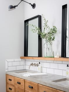 a bathroom with two sinks and a mirror on the wall above it is featured in an instagram