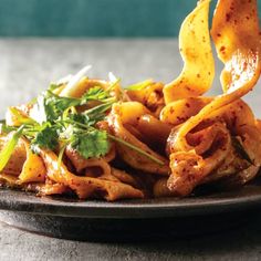 a plate filled with pasta and sauce on top of a table