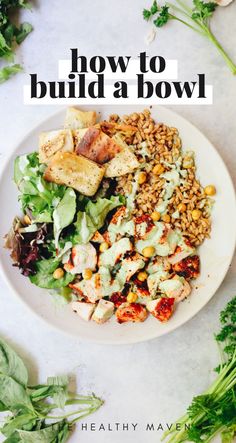 a white plate topped with salad next to lettuce and other vegetables on a table