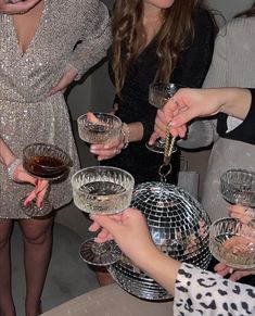 several women are holding wine glasses in their hands