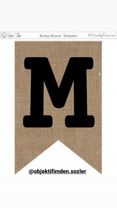 the letter m is made out of burlock and has black letters on it