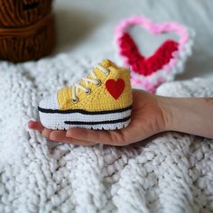 Handmade Crochet Baby Sneakers: Bright Yellow Booties with Love Heart Emblem - Perfect Newborn Gift, Baby Shower Present, and Customizable Footwear Welcome to my cozy corner of handmade treasures! Every single stitch of these baby sneakers is crafted with love, precision, and premium quality yarns, capturing the essence of those iconic shoes we all know and adore, without ever mentioning any names. 😉 These bright yellow baby booties, inspired by classic sneaker designs, are the epitome of style and comfort for those tiny little feet. Embellished with a radiant red heart symbol, it's a testament to the immense love we shower upon our little ones. But, if hearts aren't your thing, just let me know! We can adorn the shoes with a different emblem, like a star or a cute little teddy. Why These Cute Low-top Sneakers For Gift, Cute Soft Sole Booties As Gift, Cute High-top Sneakers As Gift, Cute High-top Booties With Soft Sole, Casual Booties With Soft Sole As Gift, Handmade Casual Booties As Gift, Cute Low-top Booties For Playtime, Newborn Announcement, Gender Reveal Gifts