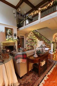 a living room filled with furniture and christmas decorations