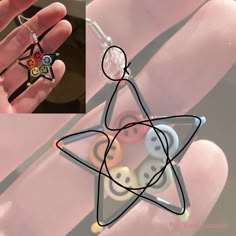 a hand holding a small star shaped object with buttons on it's thumb and an image of a person wearing a ring