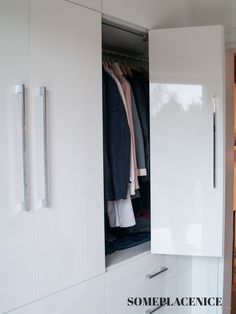 an open closet with clothes hanging in it