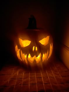 a carved pumpkin sitting on top of a bed