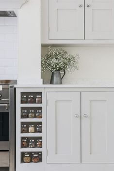 a kitchen with white cupboards and an oven in the back ground, filled with food