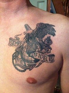 a man with a tattoo on his chest has an eagle, globe and banner around it