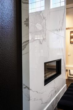 a white marble fireplace in the corner of a room