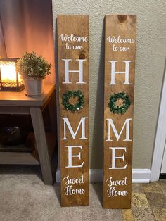 two wooden signs that say welcome to our home and sweet home with wreaths on them